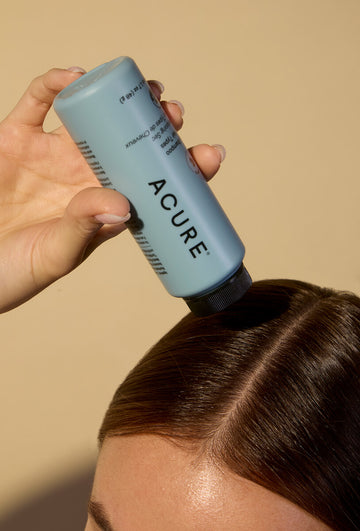 Woman applying dry shampoo
